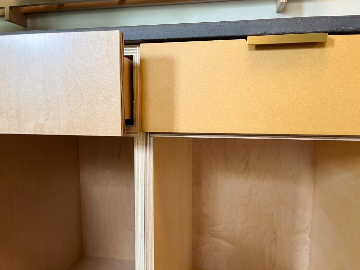 Our cabinets are made without edge banding, and designed to show off the beautiful edges of our high-quality plywood cases and fronts. The cabinet on the left shows a clear-coated maple veneer finish, while the cabinet on the left is our "Butternut Squash" custom color finish over Medex. 